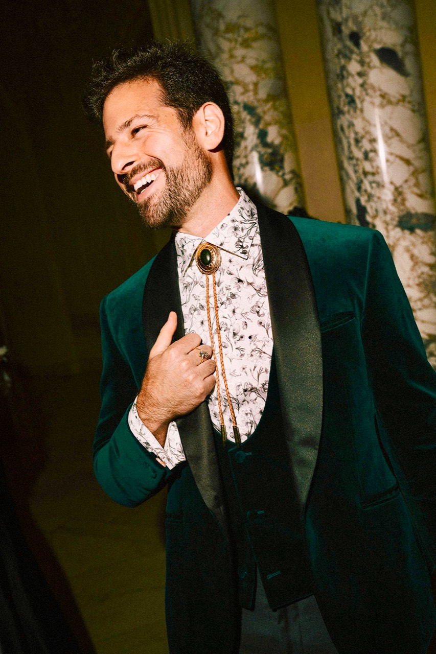 Zachary Casler smiling in an emerald velvet jacket
